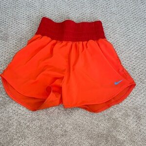 red and orange nike high waisted shorts